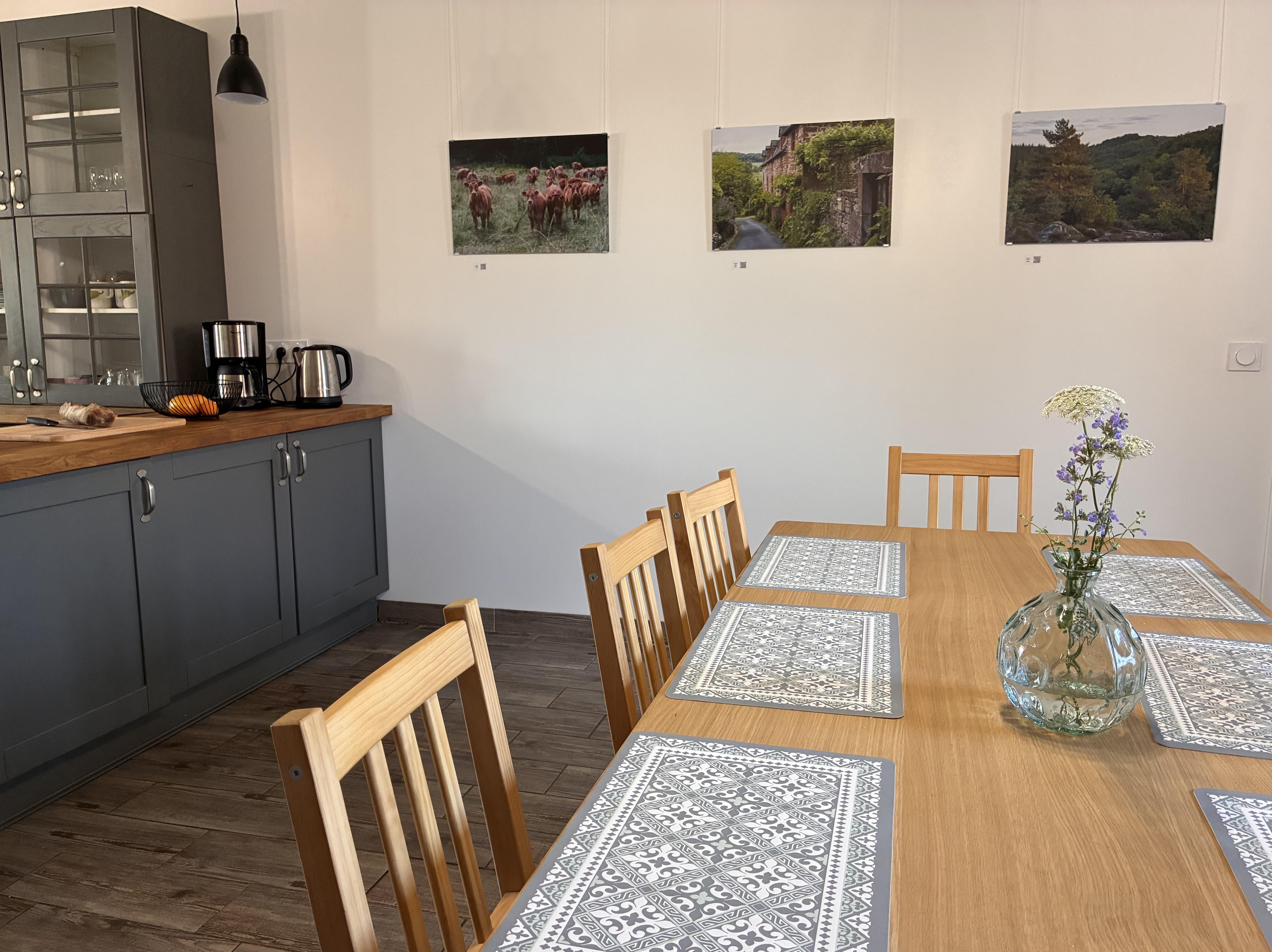 Three nature-themed aluminum prints hanging in a dining area using Nielsen rails.